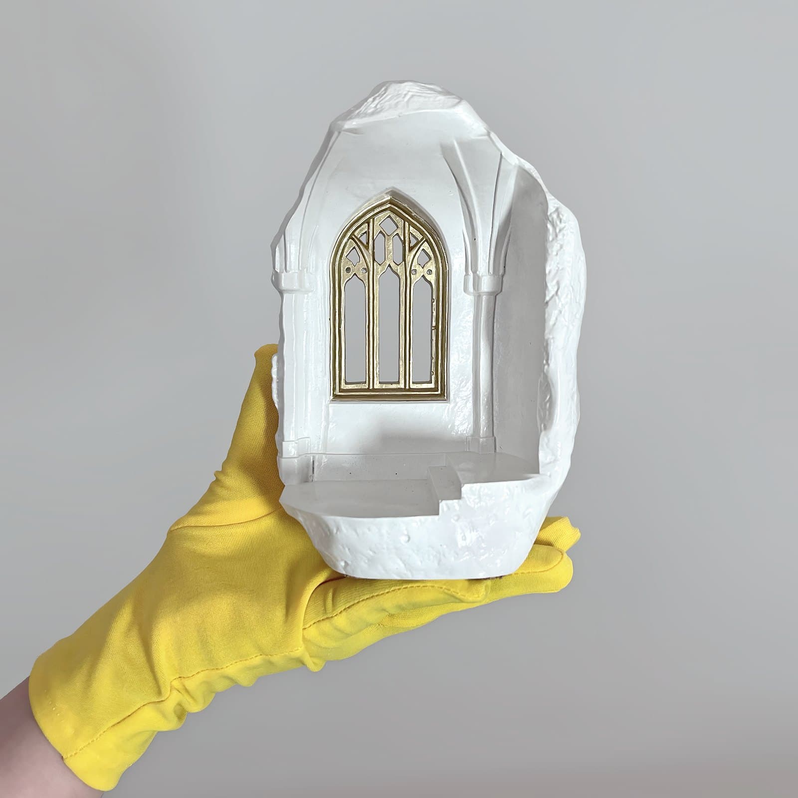 Candle holder shown in hand for scale